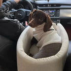 Small dog sitting in a beige FurFree pet car seat inside a vehicle